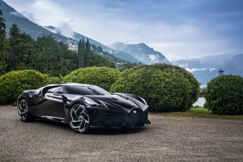 Image black porsche 911 on road near green trees and mountains during daytime