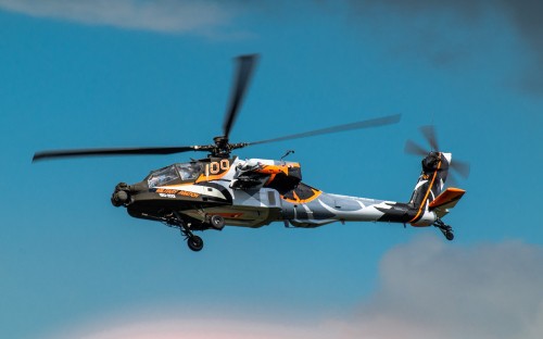 Image orange and black helicopter flying in the sky