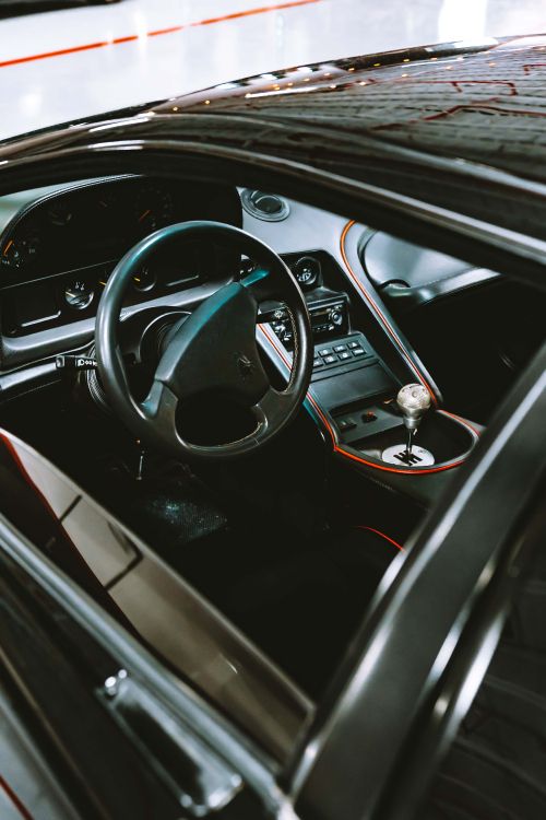 black and red car steering wheel