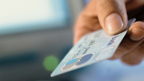 Image person holding white and blue card