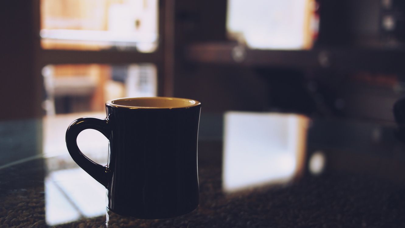 black ceramic mug on table