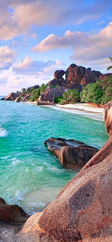 Image brown rock formation near body of water during daytime