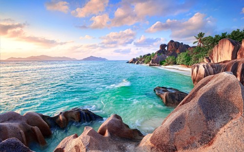 Image brown rock formation near body of water during daytime