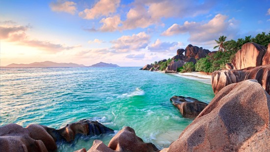 Image brown rock formation near body of water during daytime