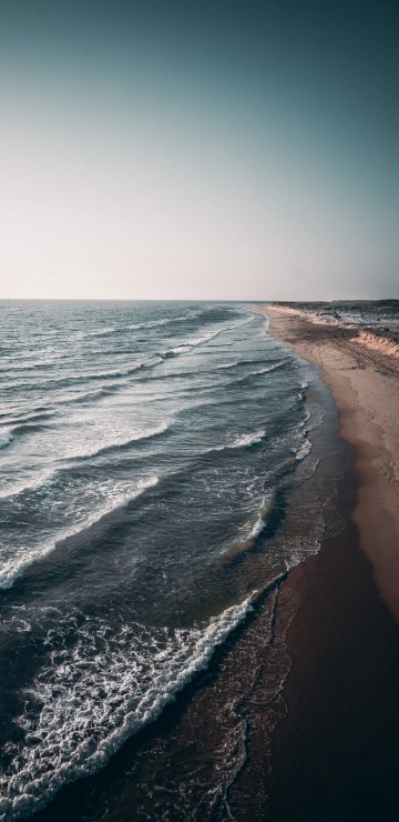 Image ocean waves crashing on shore during daytime