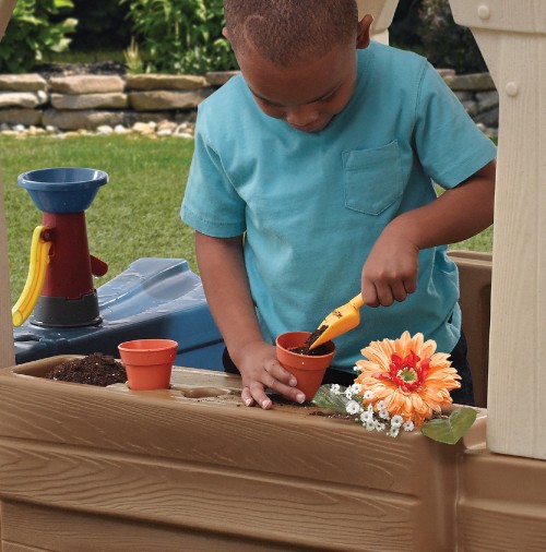 Image man in blue crew neck t-shirt holding orange plastic toy