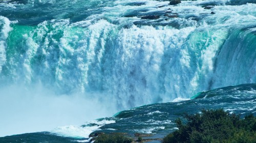 Image water falls on rocky shore during daytime