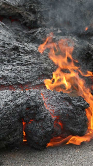 Image black and red fire on gray sand