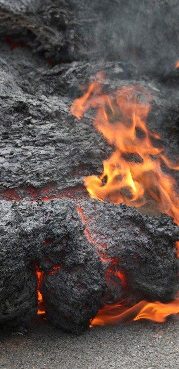 Image black and red fire on gray sand