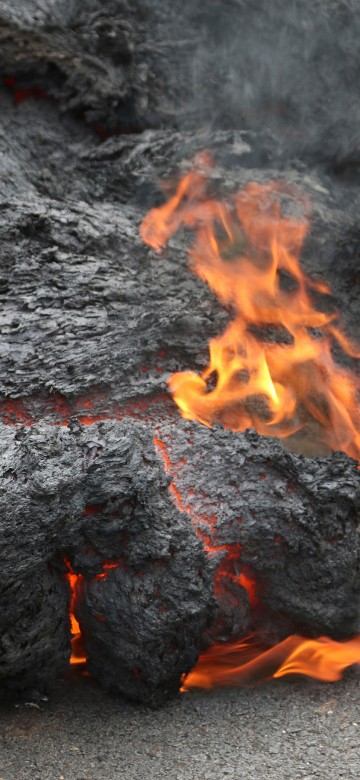 Image black and red fire on gray sand