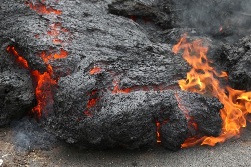 Image black and red fire on gray sand