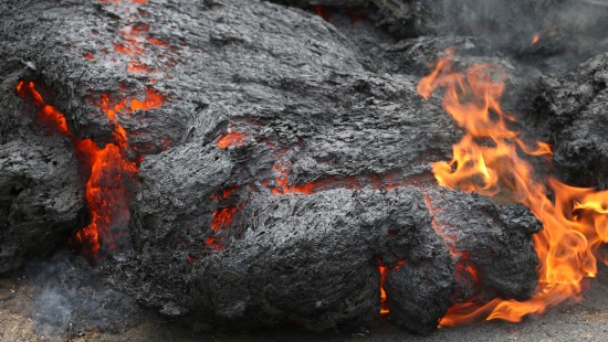 Image black and red fire on gray sand