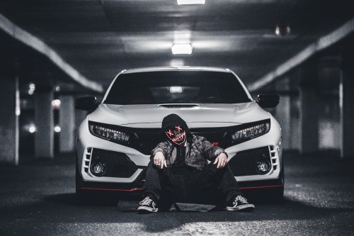 Image man in black jacket and black pants sitting on white mercedes benz car