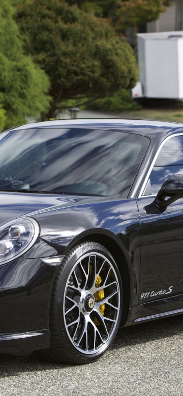 Image black porsche 911 parked on gray asphalt road during daytime