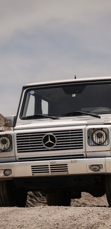 Image white jeep wrangler on brown rocky field under white cloudy sky during daytime