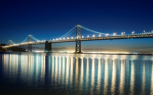 Image bridge over water under blue sky during daytime