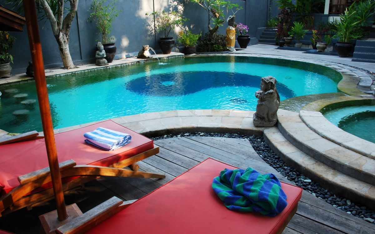 blue textile on red and blue mat near swimming pool