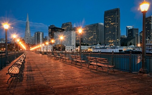 Image brown wooden chairs and tables on brown wooden dock during night time