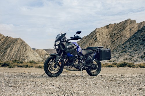 Image black motorcycle on brown field during daytime