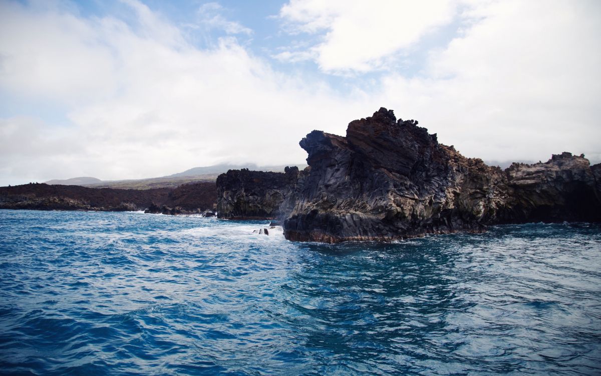 Braune Und Grüne Felsformation Auf Blauem Meer Unter Weißen Wolken Und Blauem Himmel Tagsüber. Wallpaper in 2880x1800 Resolution