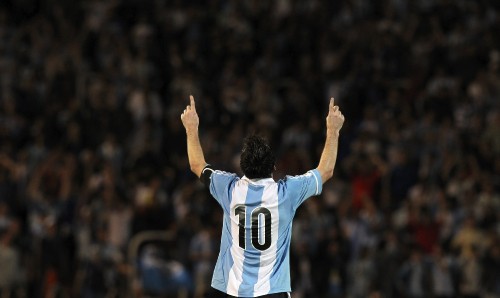 Image man in white and black jersey shirt raising his hands