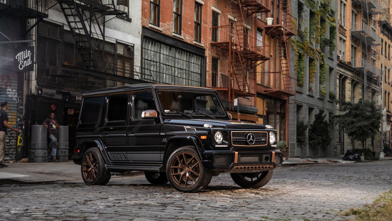 black suv parked beside brown brick building