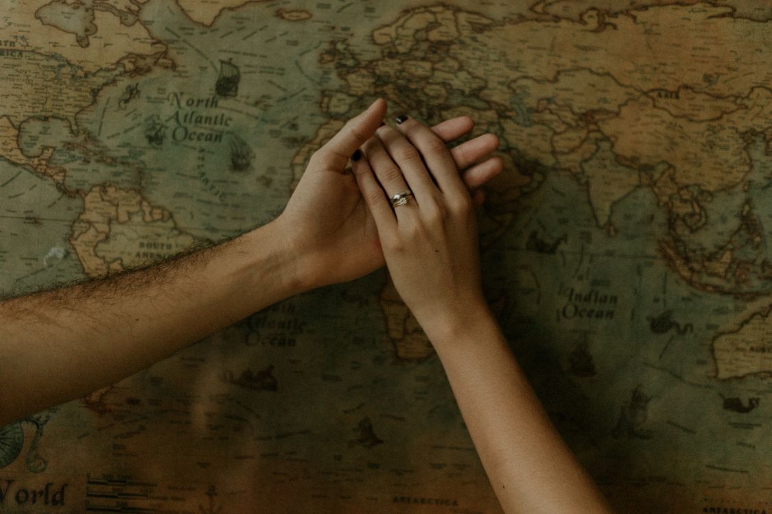 persons left hand on brown wooden surface