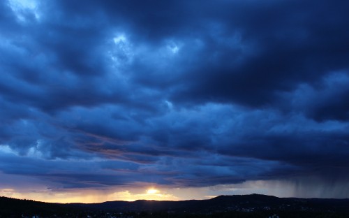 Image silhouette of mountain under cloudy sky during sunset