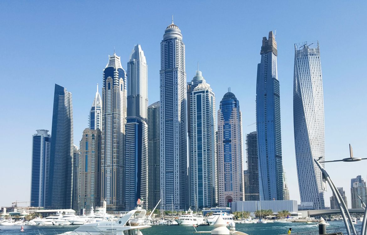 white and blue high rise buildings near body of water during daytime