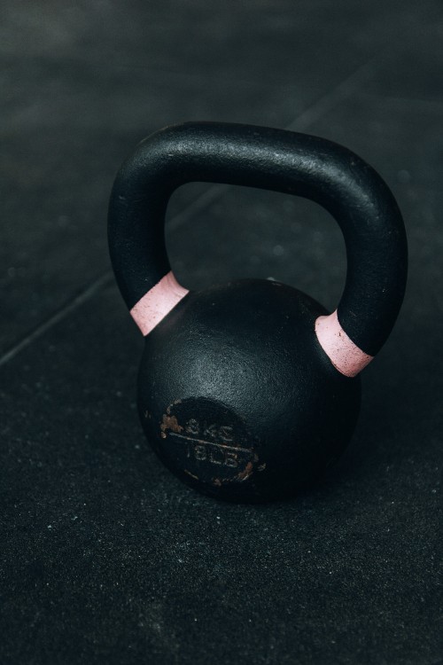 Image black kettle bell on black table