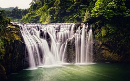 Image waterfalls in the middle of green trees