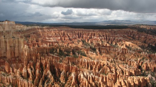 Image brown and green mountains under white clouds during daytime