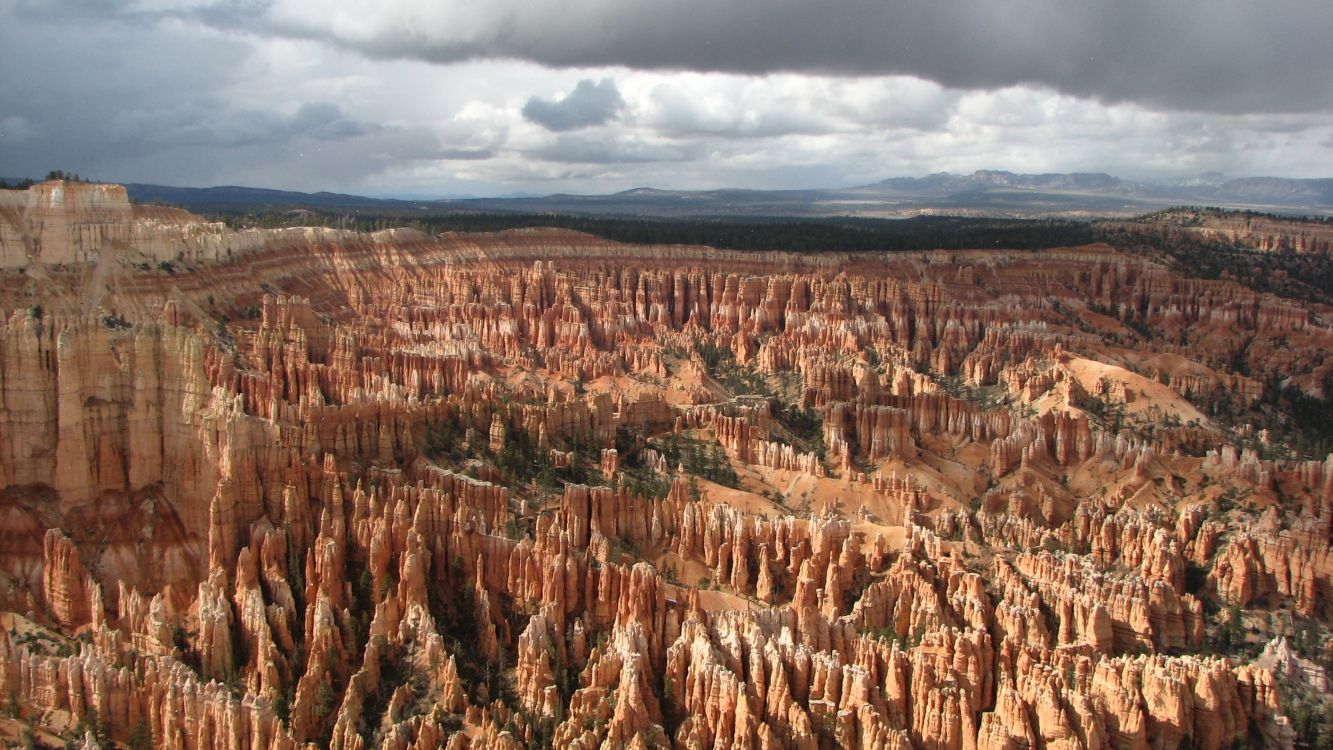 brown and green mountains under white clouds during daytime