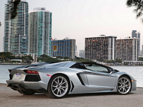 Image black lamborghini aventador parked on gray pavement