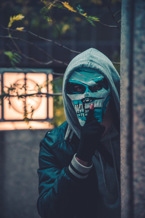 Image person in black leather jacket wearing mask