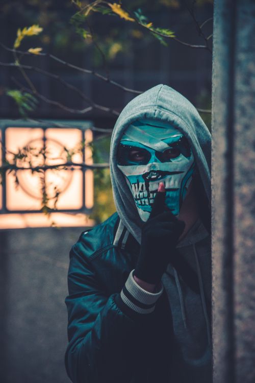 person in black leather jacket wearing mask