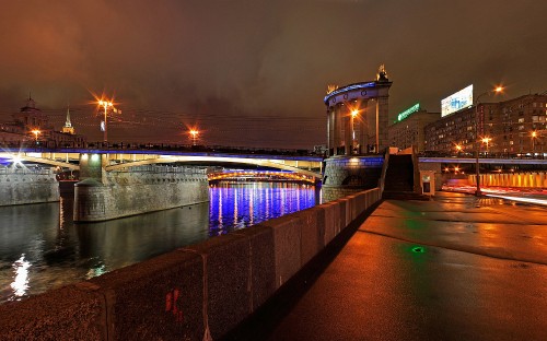 Image brown concrete bridge over river during night time