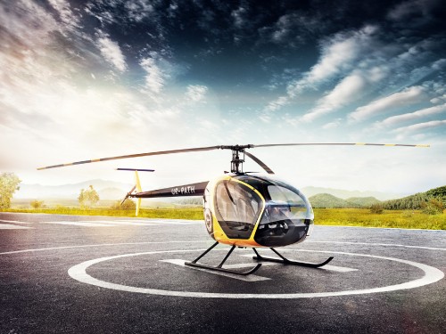 Image black and yellow helicopter on gray concrete road under blue sky during daytime