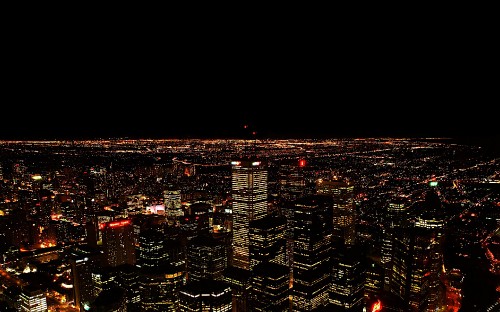 Image city with high rise buildings during night time