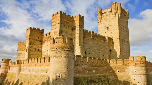 Image brown concrete castle under cloudy sky during daytime