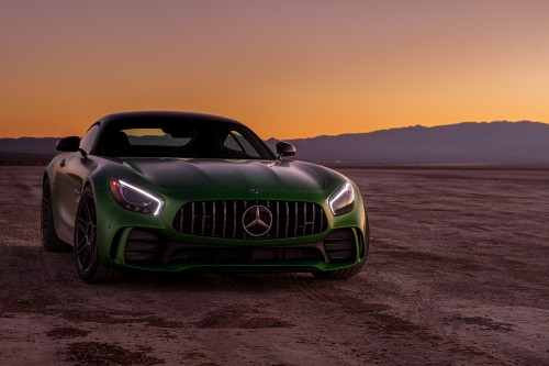 Image green bmw m 3 coupe on beach shore during sunset