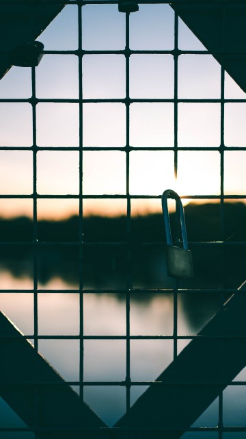 Image black metal fence with padlock