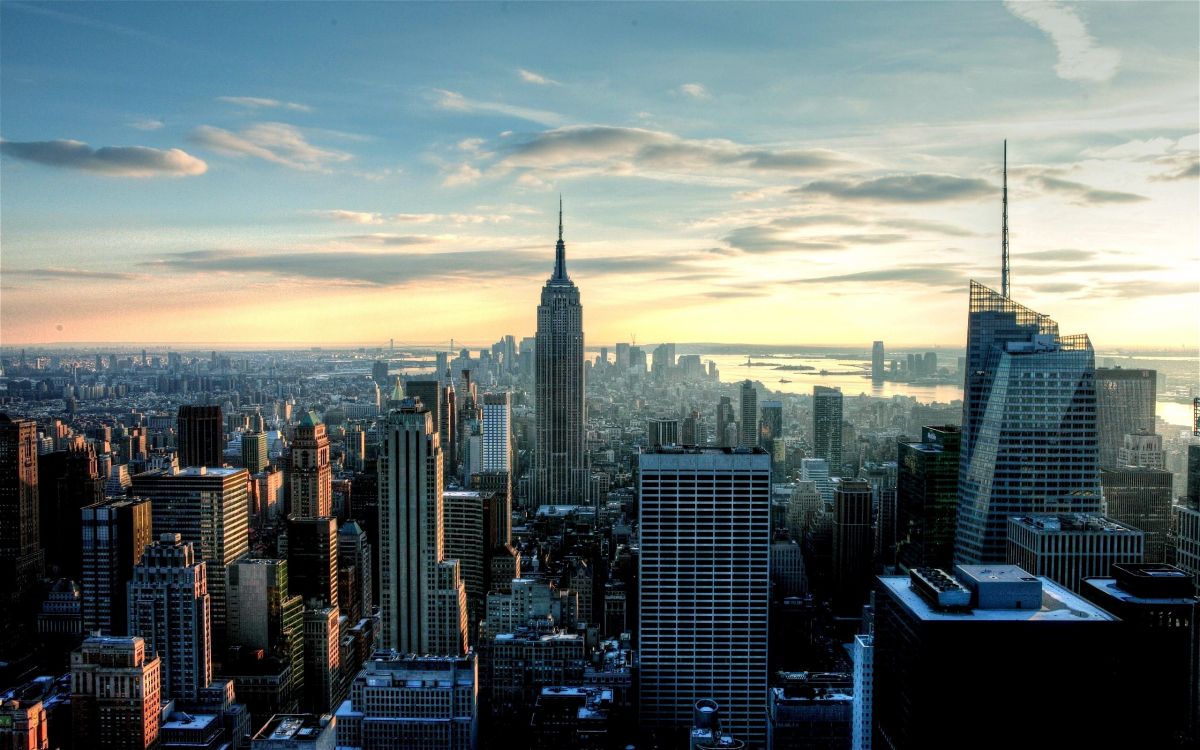 city skyline under white clouds during daytime