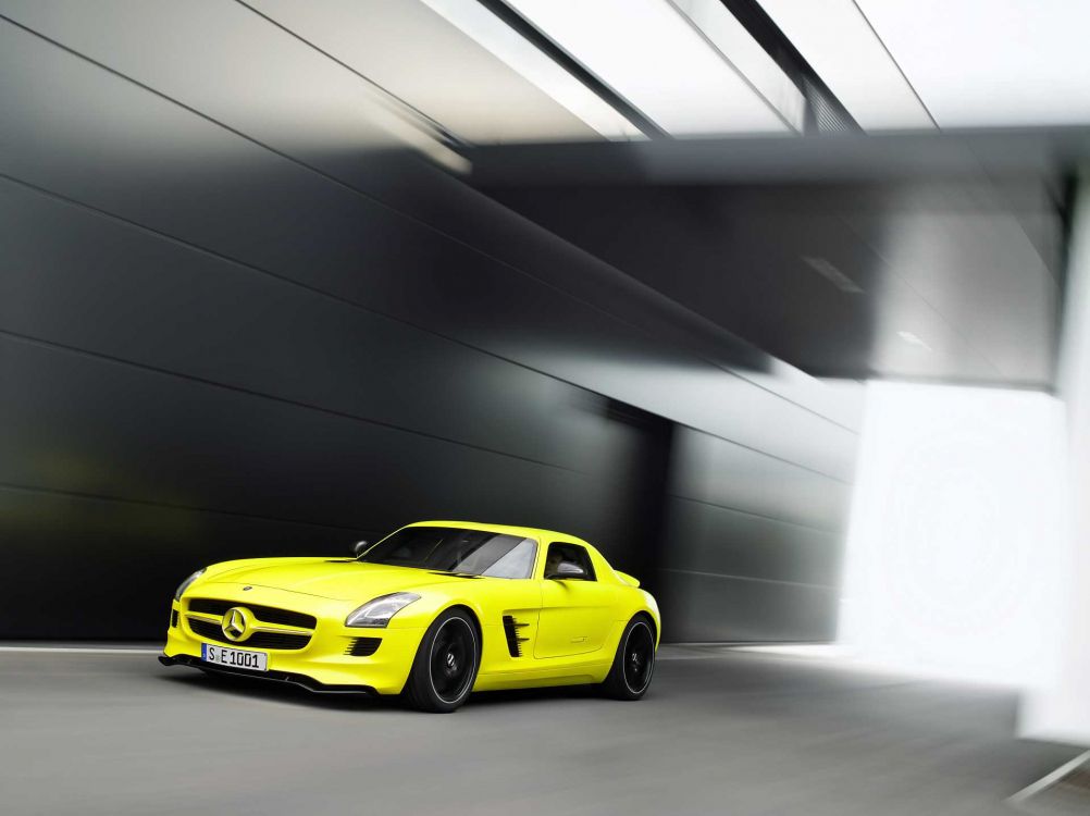 yellow porsche 911 parked in garage