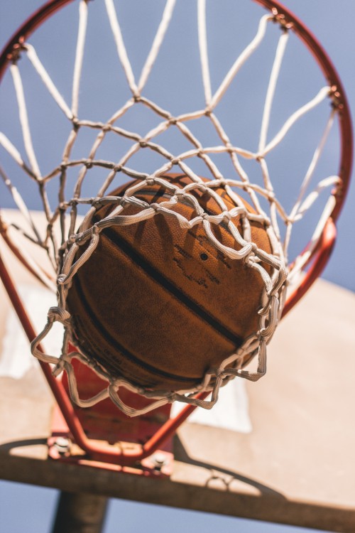 Image brown basketball on basketball hoop