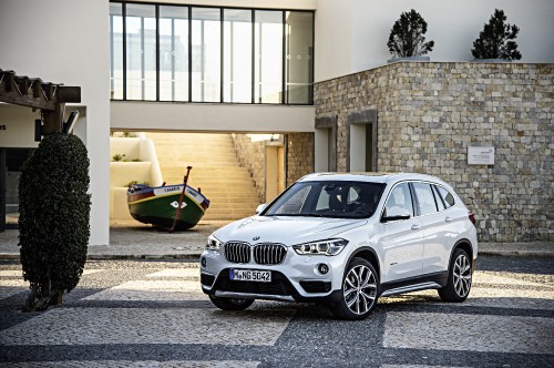 Image silver bmw m 3 parked beside beige building