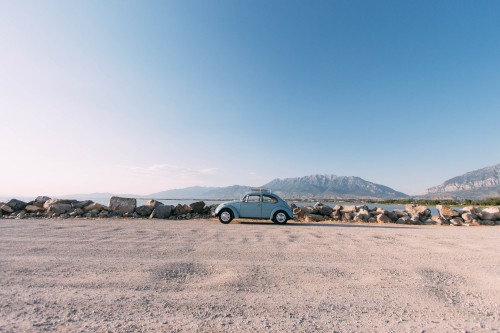 Image blue car on brown sand during daytime