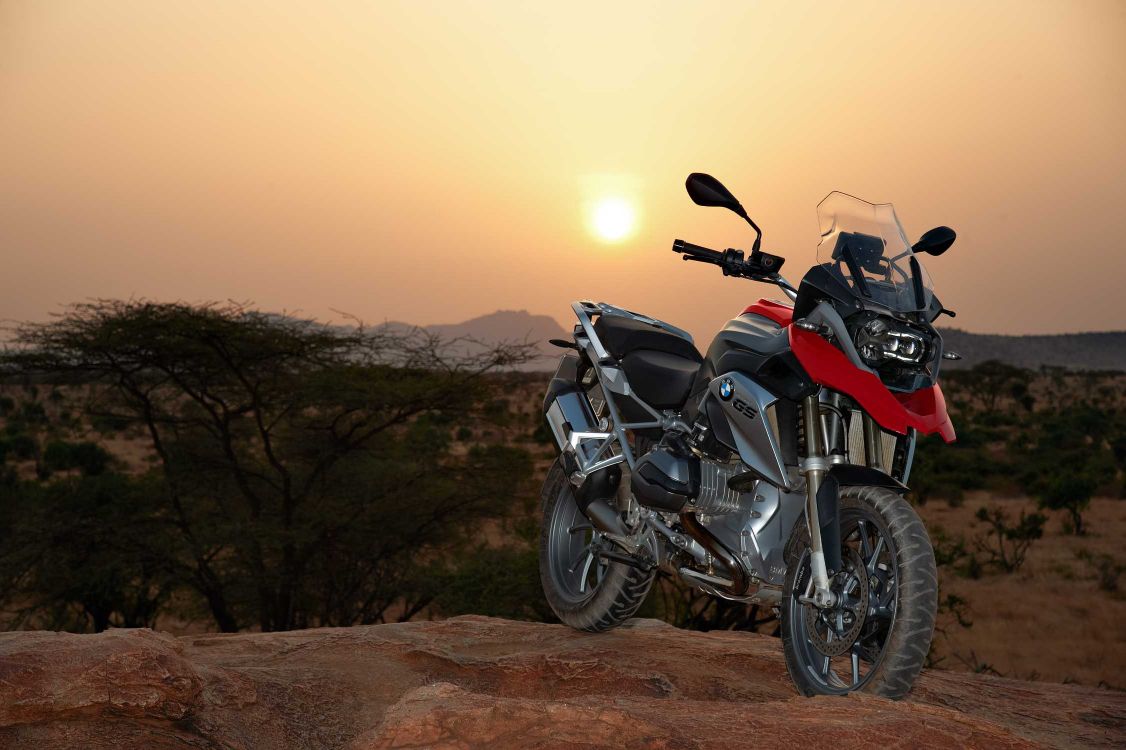 black and red naked motorcycle on brown dirt road during daytime