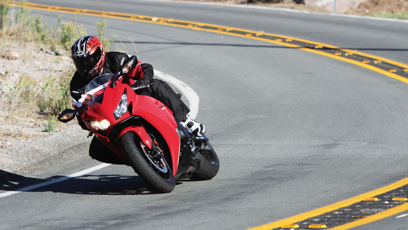 Man in Red and Black Sports Shirt Riding Red Sports Bike on Road During Daytime. Wallpaper in 3840x2160 Resolution