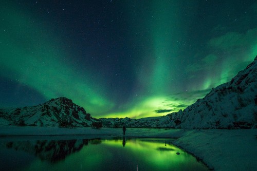 Image body of water near mountain during night time